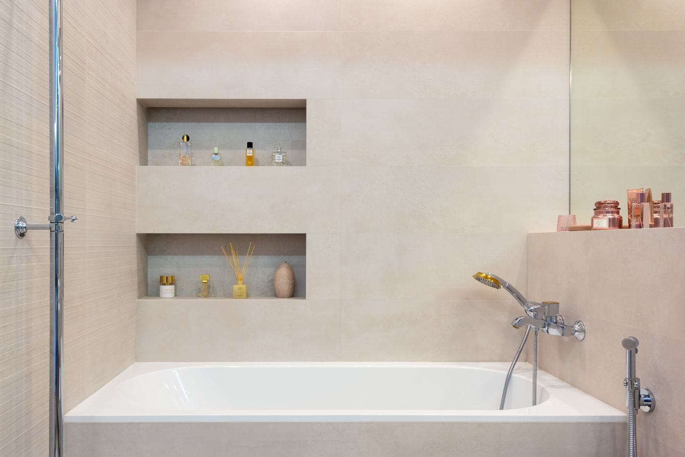 Bathroom interior with bathtub with shower under shelves — illustrative Pexels photograph