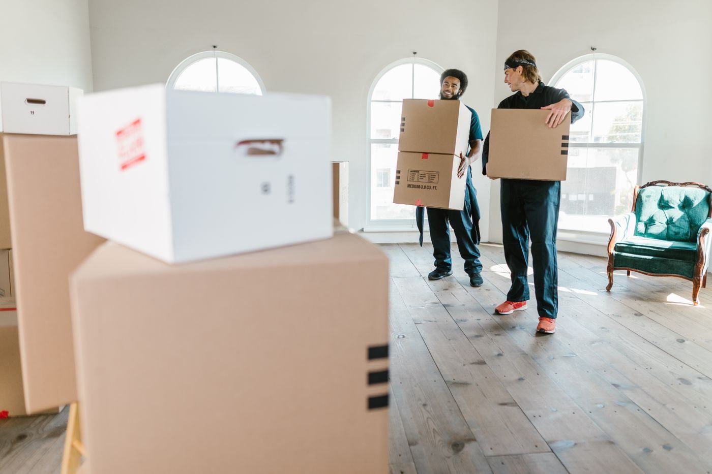 Two Men Carrying Boxes — illustrative Pexels photograph
