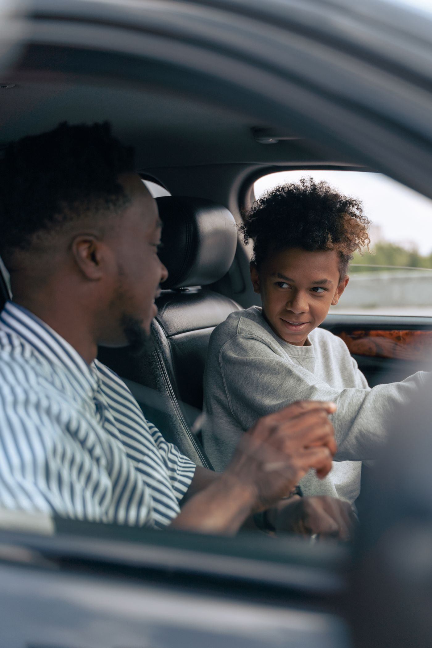 Man in White and Blue Striped Dress Shirt Driving Car — illustrative Pexels photograph