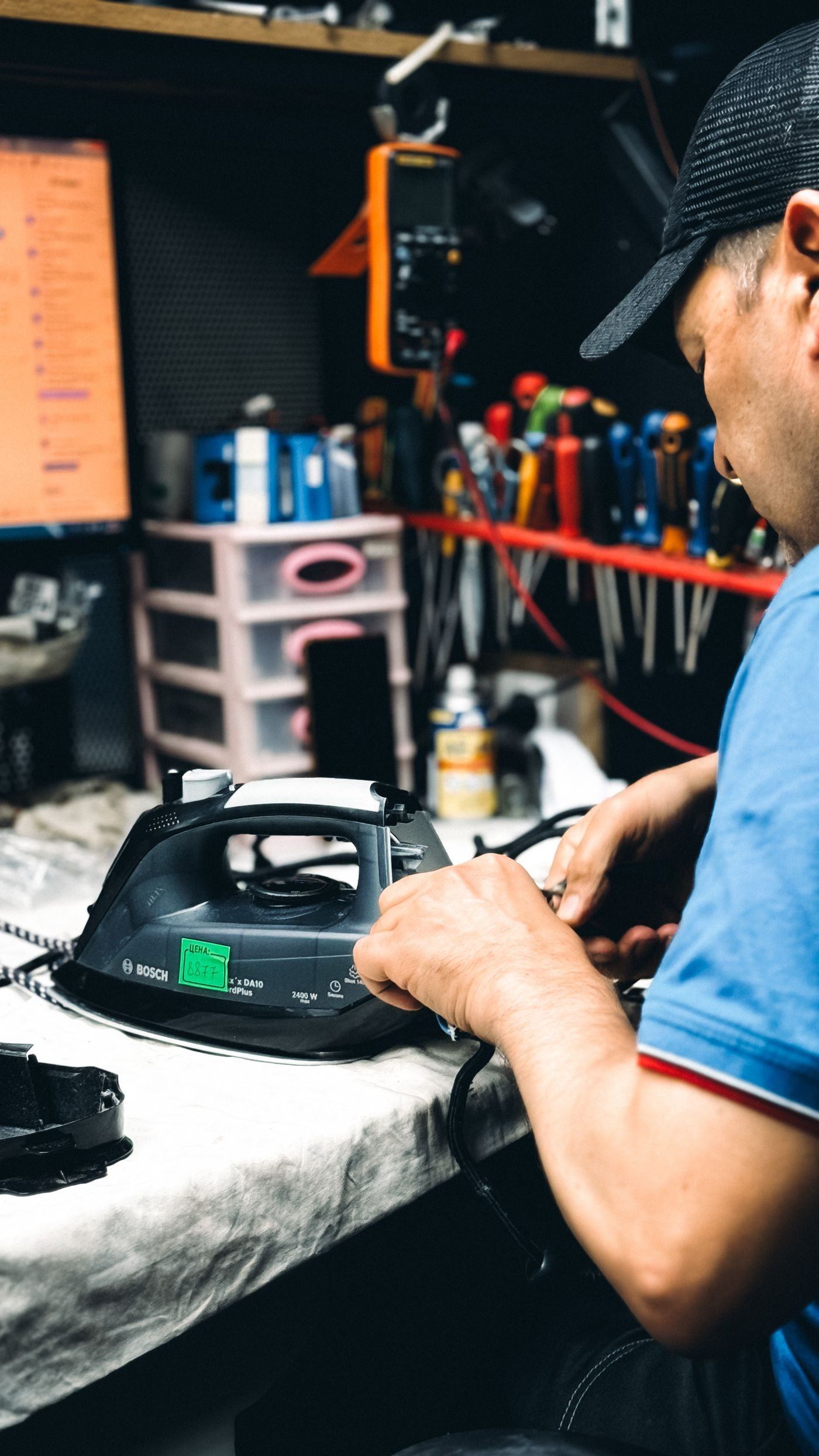 Technician repairing an electric iron — illustrative Pexels photograph