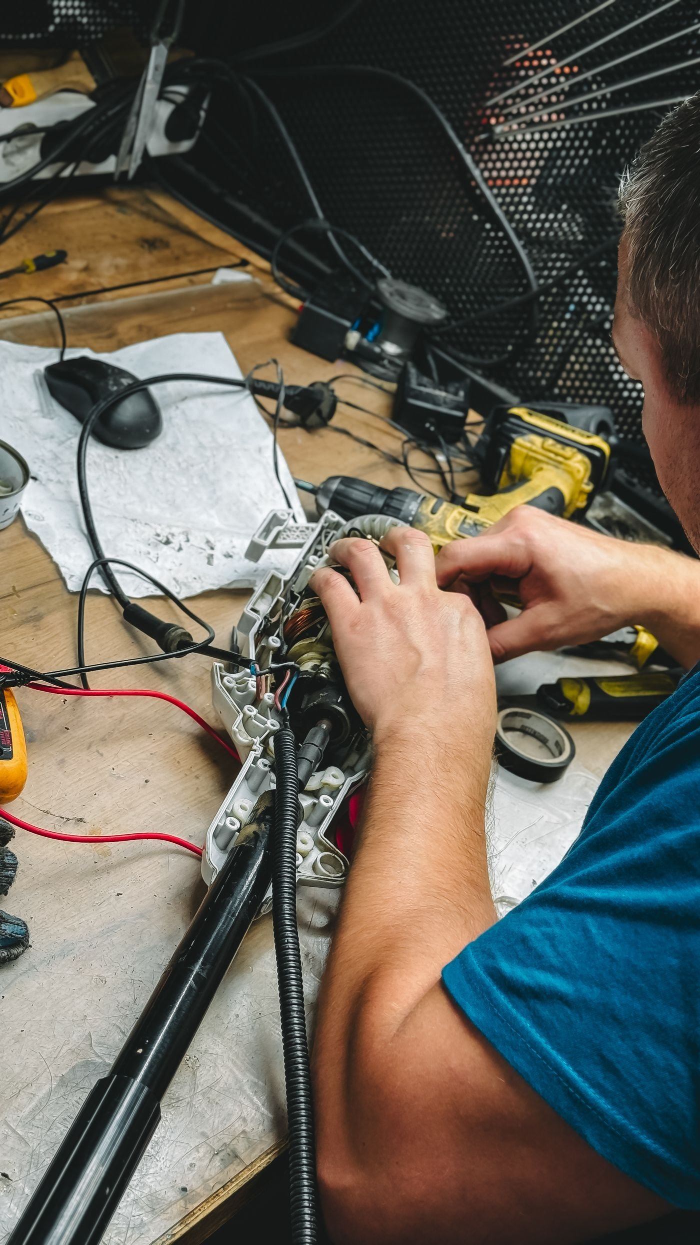 Hands repairing an electronic device — illustrative Pexels photograph