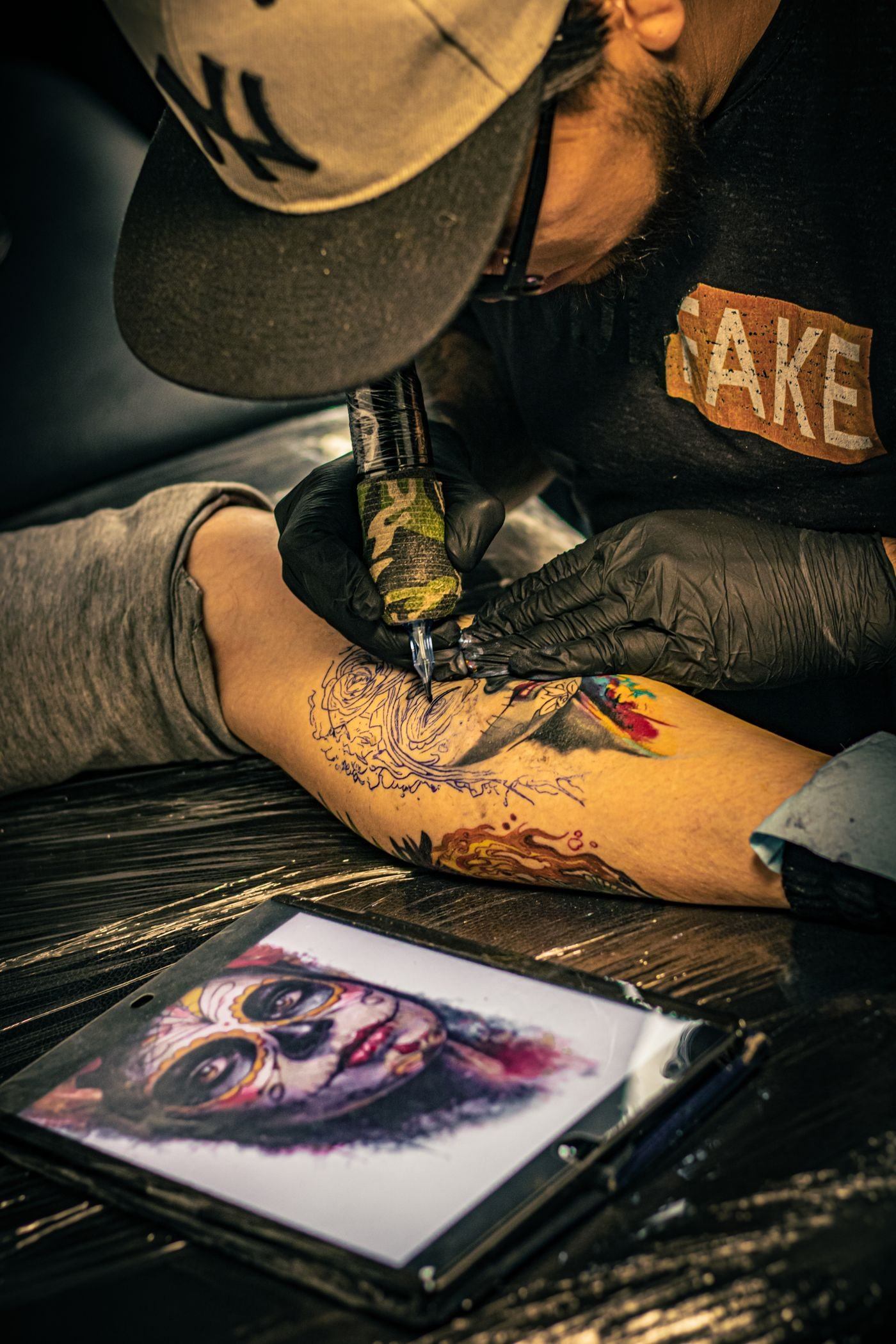 Tattoo artist working on an arm — illustrative Pexels photograph